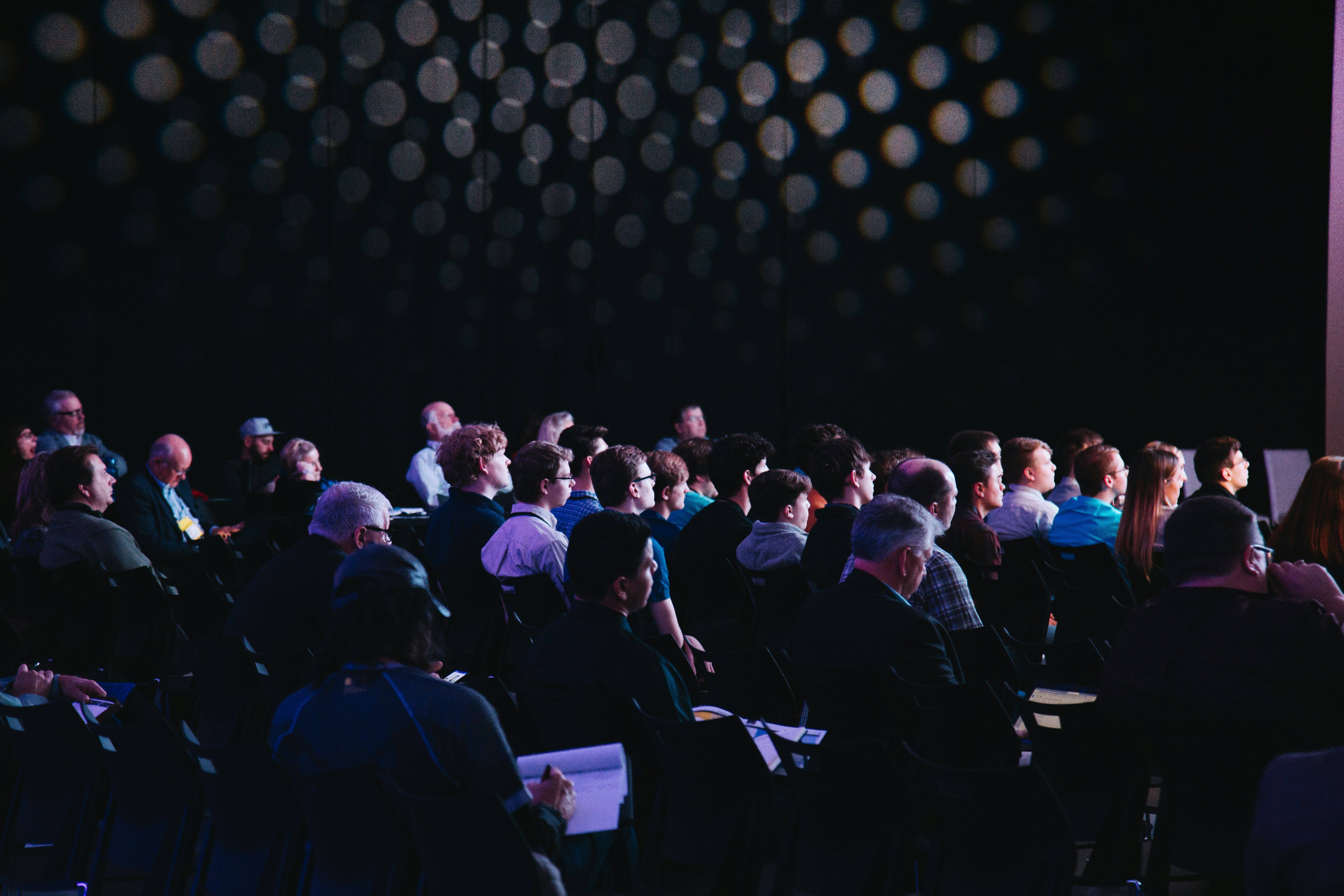 Tech conference stage with full audience